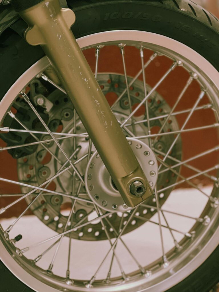 Detailed close-up image of a motorcycle wheel with visible spokes and tire tread.