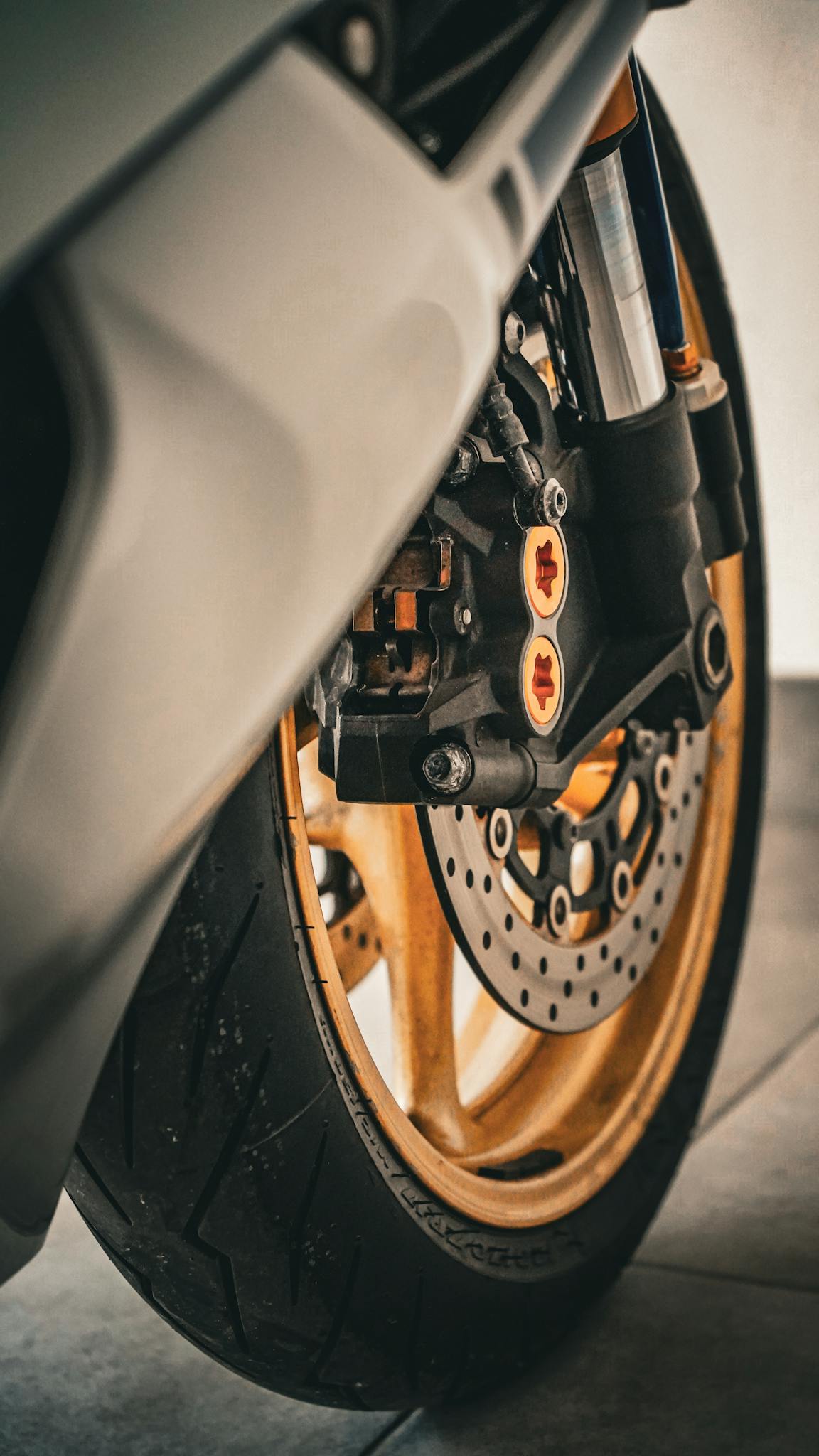 Detailed close-up of a motorcycle's front wheel brake showcasing its intricate mechanisms.